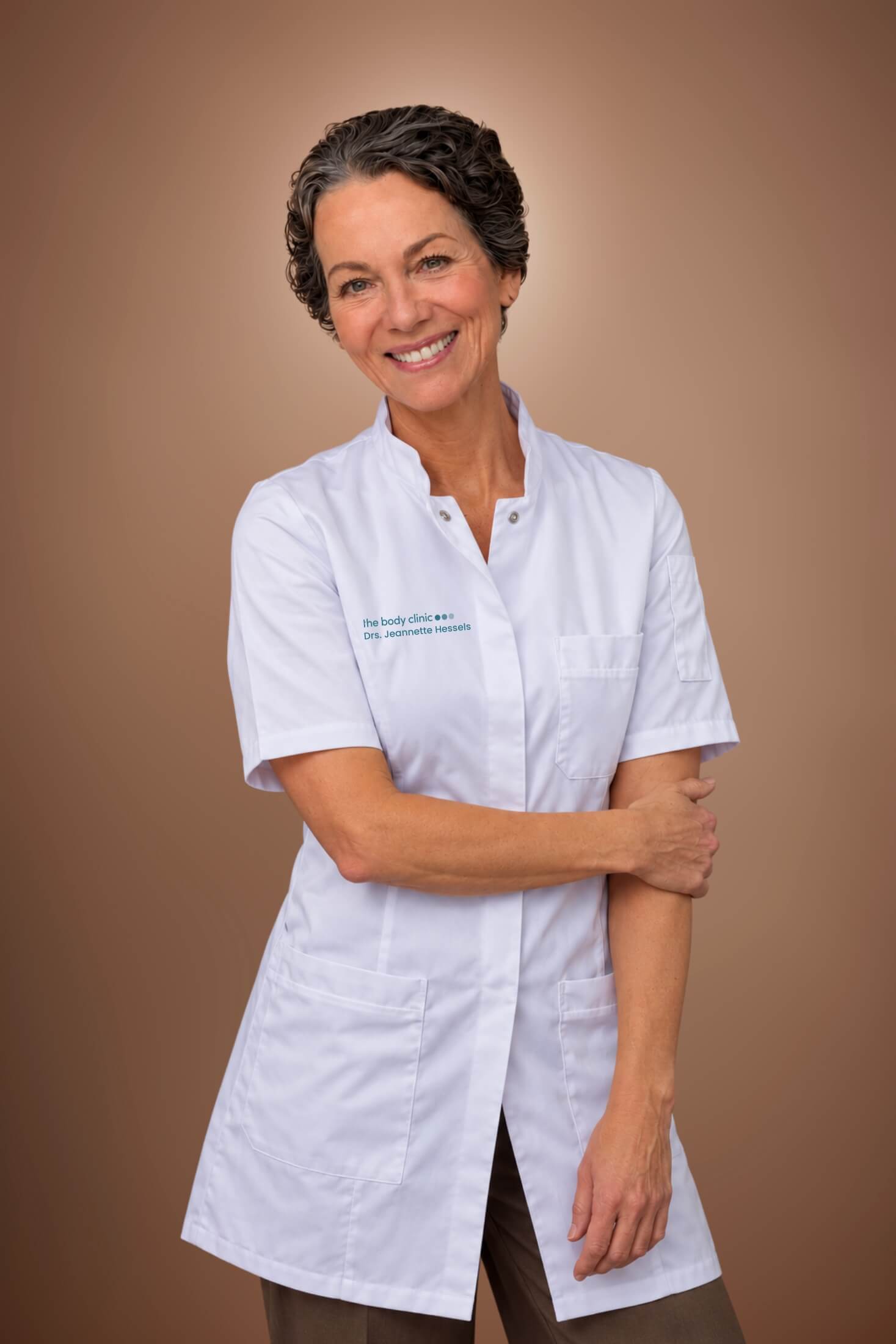 Smiling woman in white medical coat with short hair standing confidently.