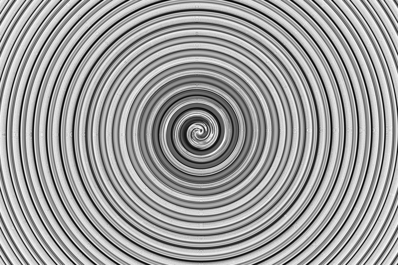 A striking black and white spiral pattern creates a hypnotic optical illusion.