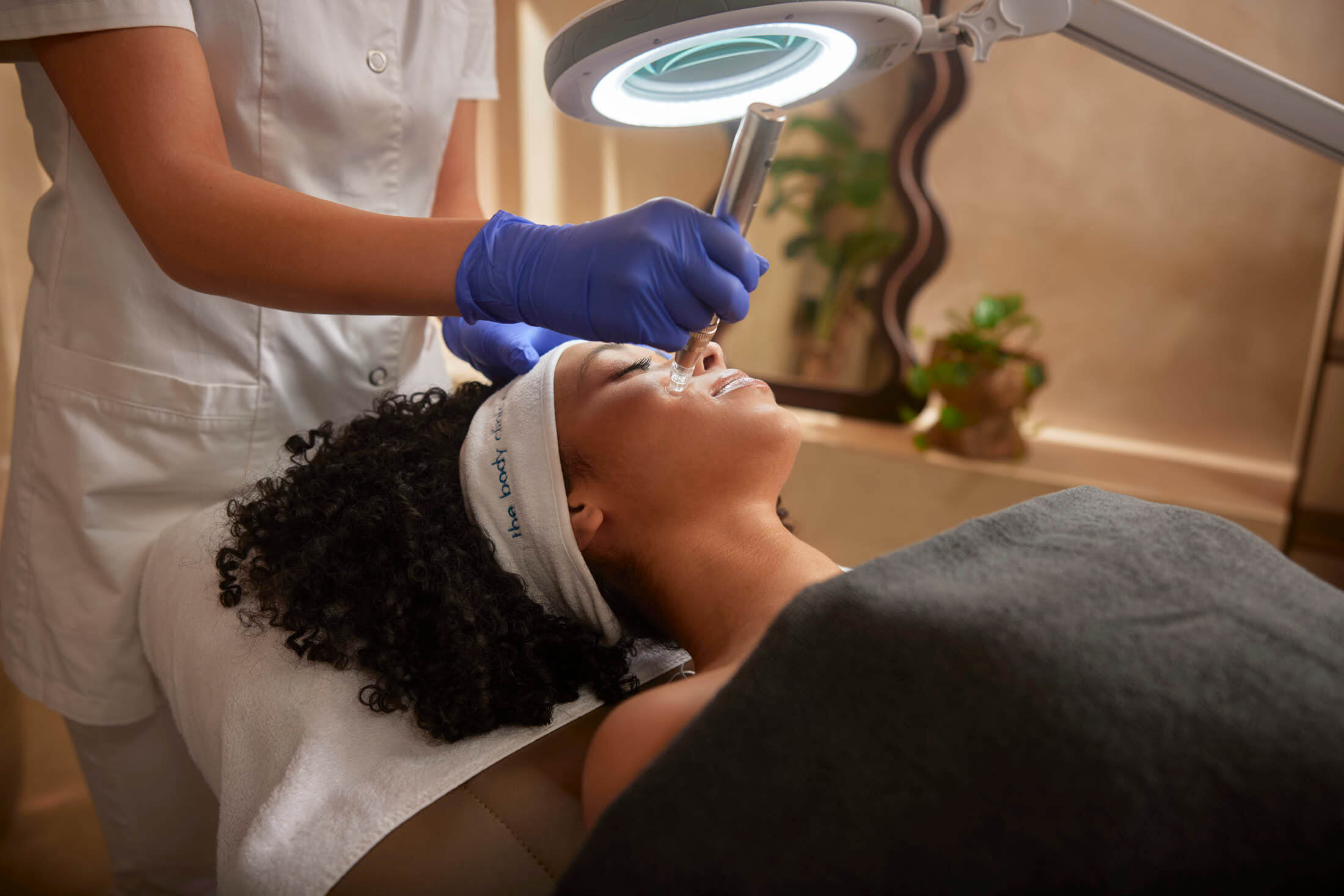Skin therapist treating acne-prone skin at The Body Clinic
