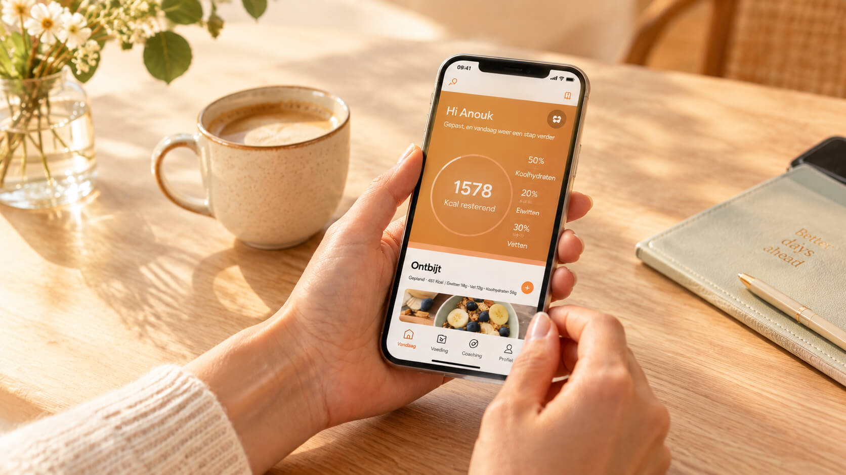 Hands hold a smartphone displaying a health or coffee tracking application at a sunny table.