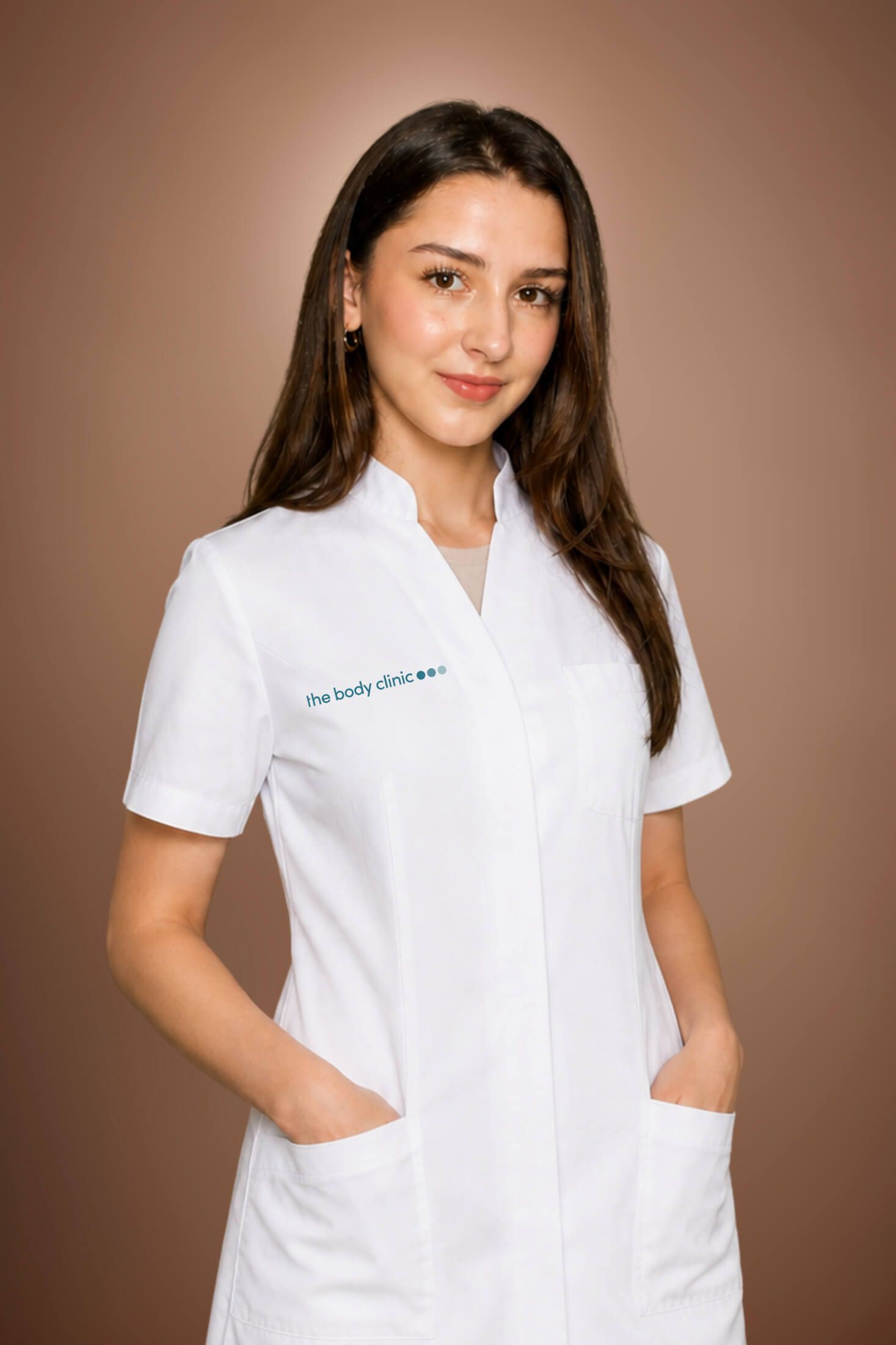 Young woman in white medical coat smiling with hands in pockets.