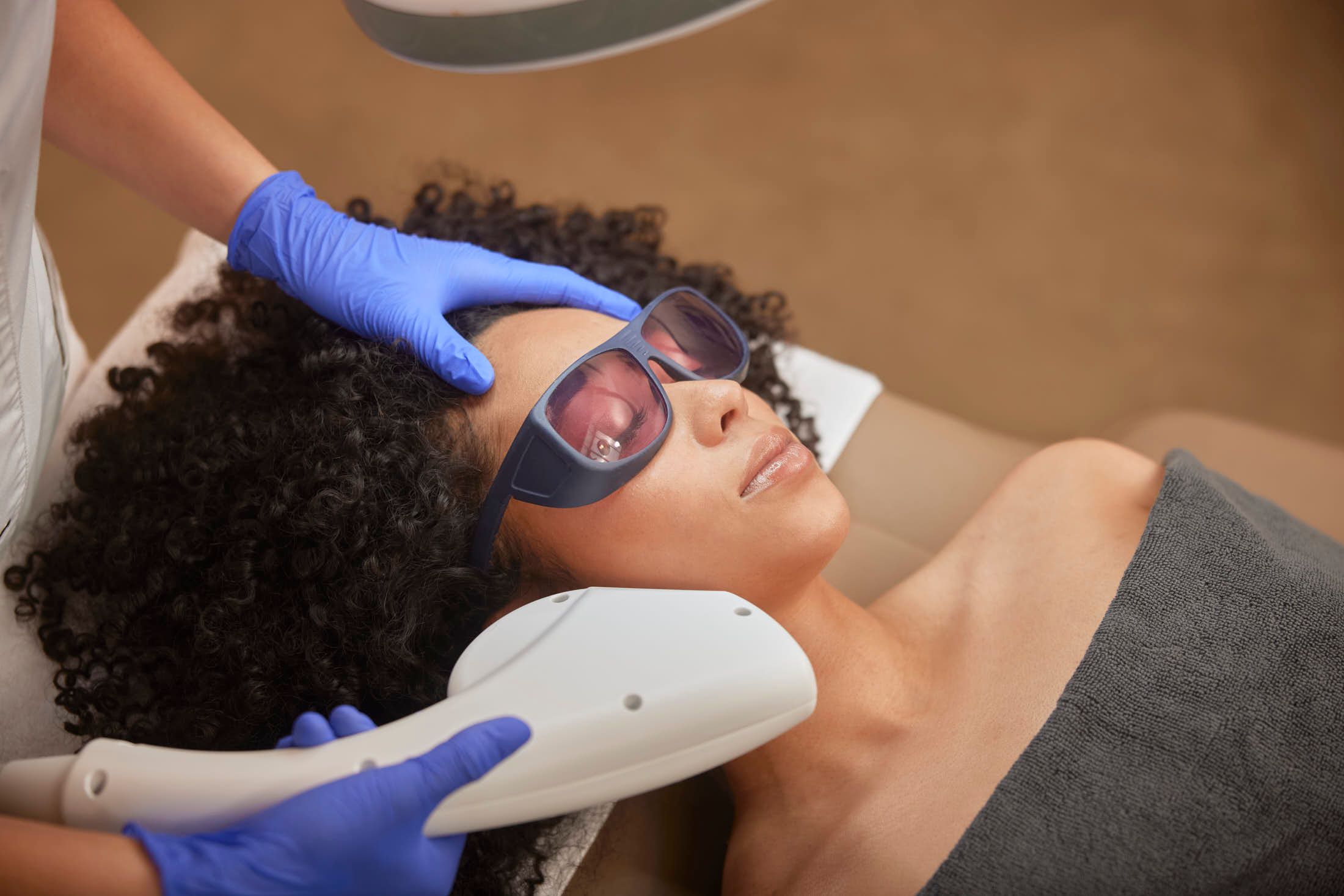 Huidtherapeut voert lasertherapie tegen couperose uit bij client bij The Body Clinic