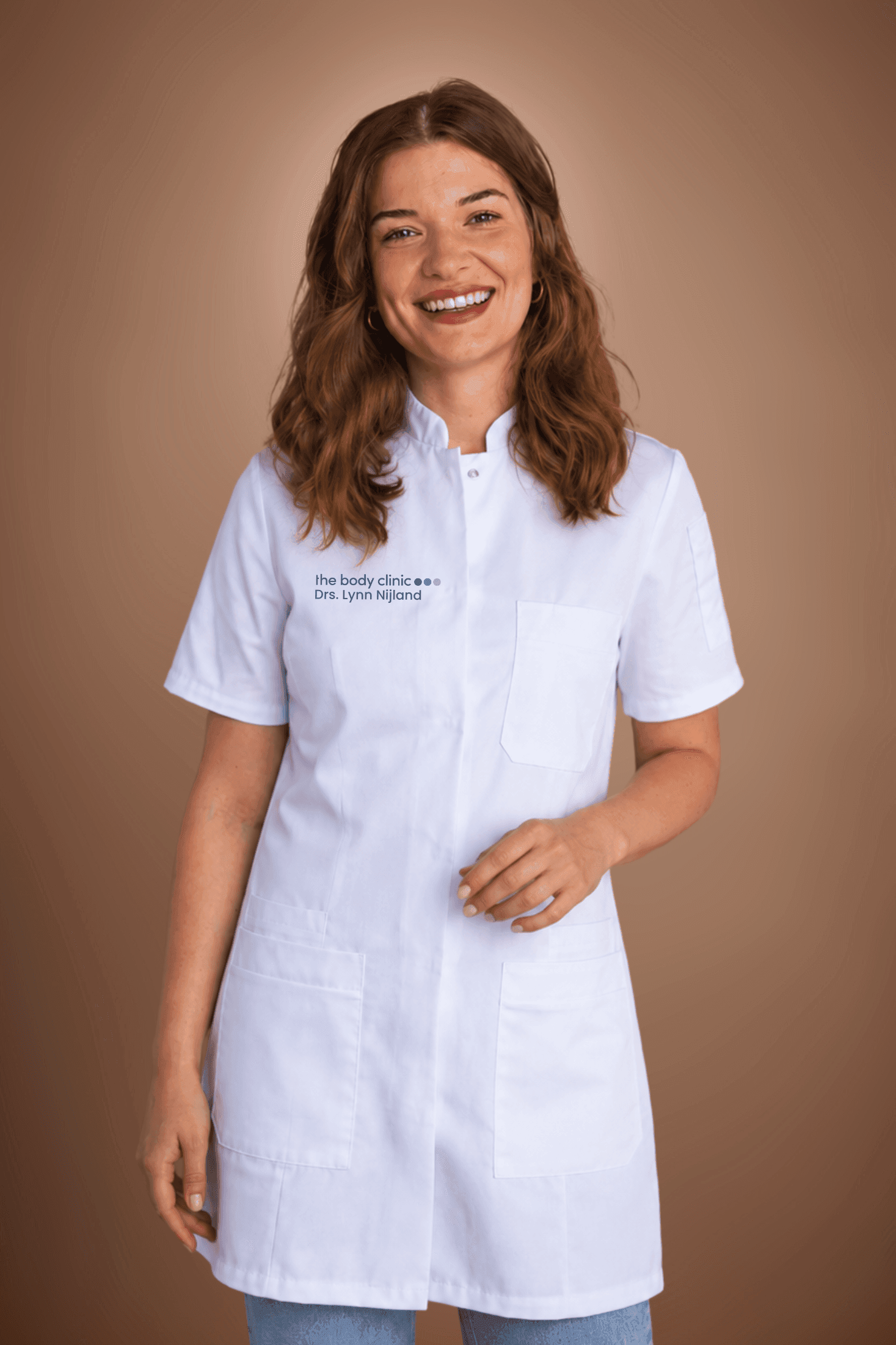 Smiling young woman in a white lab coat with braces and brown hair.